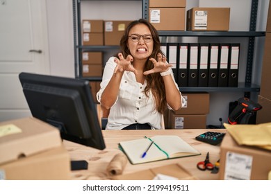 Young Hispanic Woman Working At Small Business Ecommerce Smiling Funny Doing Claw Gesture As Cat, Aggressive And Sexy Expression 