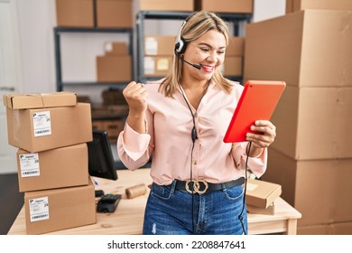 Young Hispanic Woman Working At Small Business Ecommerce Wearing Headset Screaming Proud, Celebrating Victory And Success Very Excited With Raised Arm 