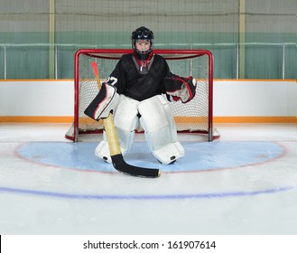 A Young Hockey Goalie Kid Protects His Net From A Goal