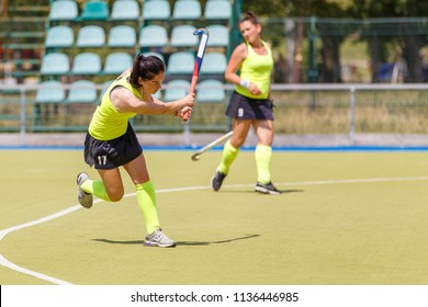 Young Hockey Player Hit The Ball In Field Hockey Game