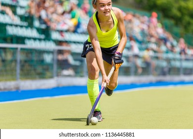 Young Hockey Player Woman With Ball In Attack Playing Field Hockey Game