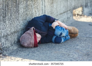 Young Homeless Boy Sleeping On The Bridge, Poverty, City, Street