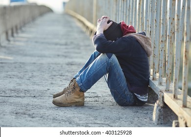 Young Homeless Boy Sleeping On The Bridge, Poverty, City, Street