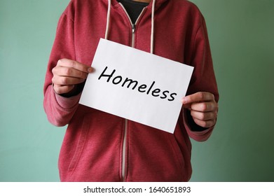 A young homeless boy stands with a sign and asks for help. Homelessness concept. - Shutterstock ID 1640651893