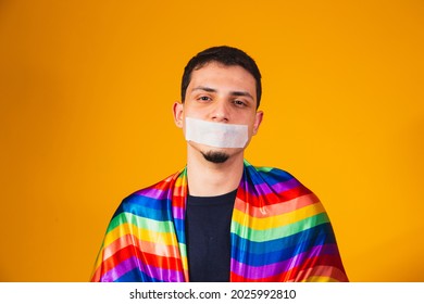 Young homosexual boy with his mouth closed in silence by the violence suffered in society. gay prejudice and violence