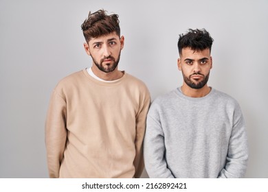 Young Homosexual Couple Standing Over White Background Depressed And Worry For Distress, Crying Angry And Afraid. Sad Expression. 