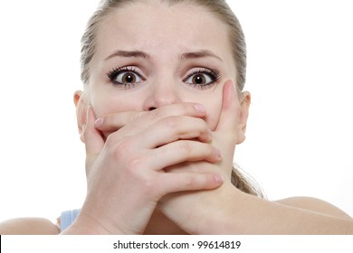 Young Horrified Woman Closing Her Mouth With Hands Over White