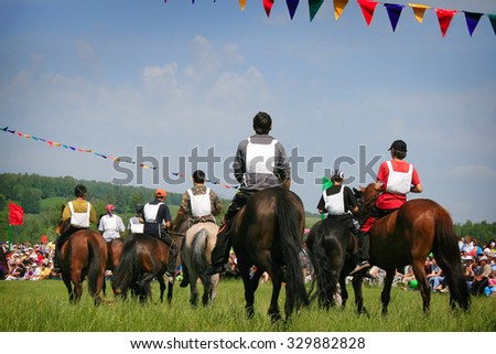 The young horsemans on horseback. Traditional horse racing in Bashkortostan on holiday sabantuy