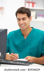 Young Hospital Doctor At Desk