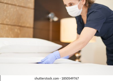 Young housemaid cleaning a luxury hotel room