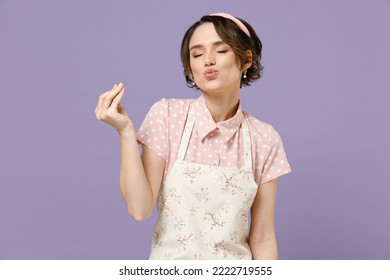 Young housewife housekeeper chef cook baker woman wear pink apron t-shirt making okay taste delight sign, savoring, delicious isolated on pastel violet color background studio. Cooking food concept.