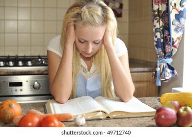 Young Housewife Reading Cookbook