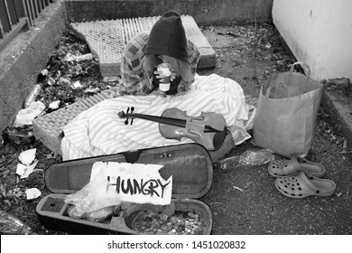 Young Hungry Homeless Woman Begging On Street