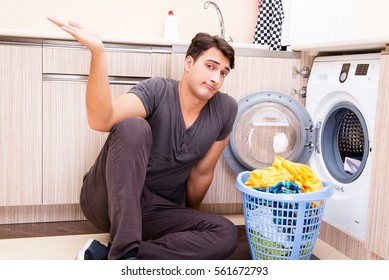 Young husband man doing laundry at home - Powered by Shutterstock