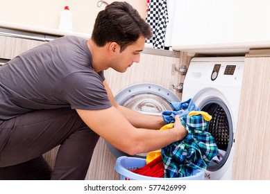 Young Husband Man Doing Laundry At Home