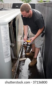 A Young HVAC Technician Working On A Commercial Air System On The Rooftop.