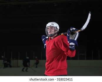 Young Ice Hockey Player Portrait On Training In Black Background