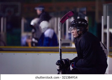 Young Ice Hockey Player Portrait On Training In Black Background