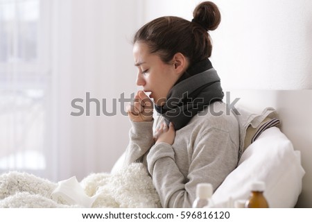 Young ill woman in bed at home