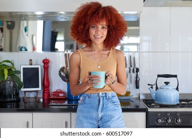 Young Independent Woman At Home In Her Kitchen 