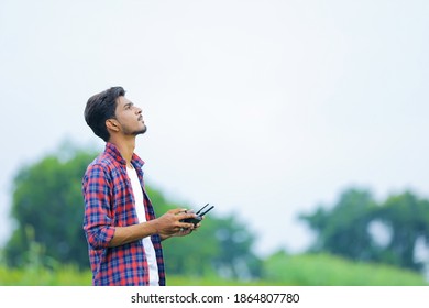 Young Indian Agronomist Operate Or Control Of Flying Drone At Agriculture Field