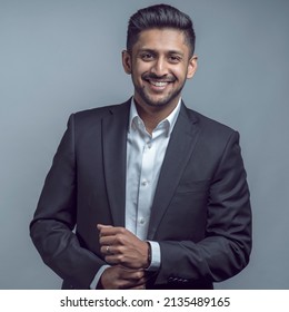 Young Indian Asian Man Wearing Black Suit And White Shirt Over Isolated Grey Or White Background Happy Face Smiling With Crossed Arms Looking At The Camera. Positive Person.