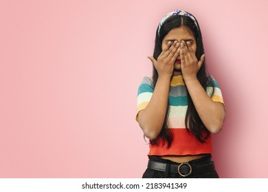 Young Indian Asian Scared Girl Posing Isolated Covering Eyes With Hands. Confused Girl Close Eyes With Palms Ignoring Something. See No Evil Concept. Mock Up Copy Space.