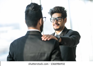 Young Indian Boss Handshake Tap Shoulder Of Employee Greeting With Work Success