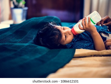 Young Indian Boy Drinking Milk From Bottle