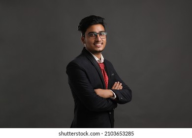 Young Indian Business Man Showing Expression On Dark Background.