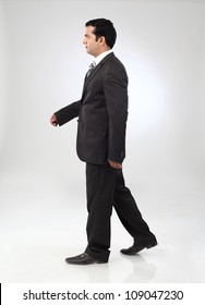  Young Indian Business Man Walking On Background