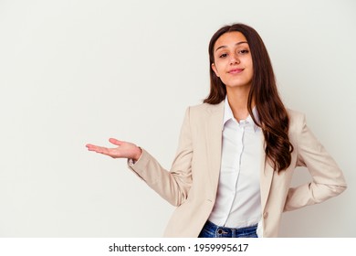 Young Indian business woman isolated on white background showing a copy space on a palm and holding another hand on waist.