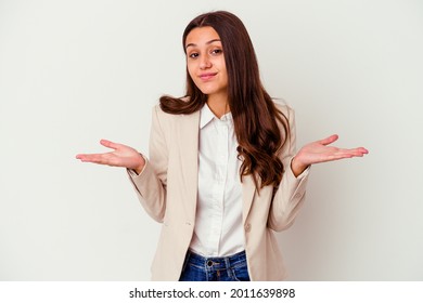 Young Indian business woman isolated on white background doubting and shrugging shoulders in questioning gesture.