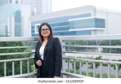 Young Indian businesswoman with a file in city