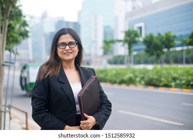 Young Indian Businesswoman With A File In City