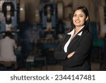 Young indian businesswoman standing at factory