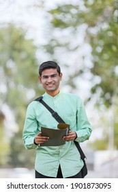 Young Indian College Student Or Job Seeker With Holding File In Hand.