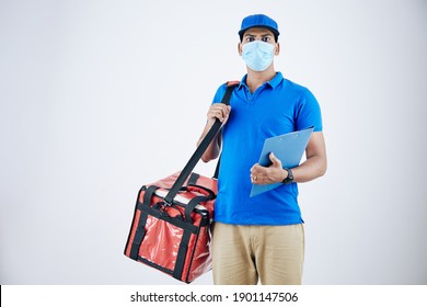 Young Indian Courier In Medical Mask Deliverying Food In Cooler Bag, Isolated On White