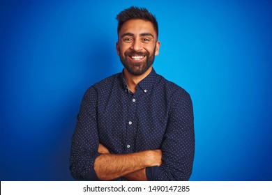 Young Indian Elegant Man Wearing Shirt Standing Over Isolated Blue Background Happy Face Smiling With Crossed Arms Looking At The Camera. Positive Person.