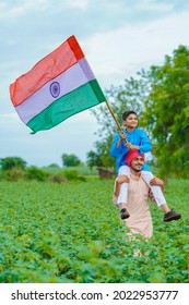 young indian farmer and his child with indian flag