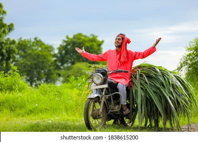 Young indian farmer transport cattle food on two wheeler