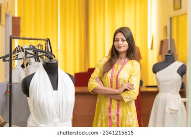 Young indian female fashion designer standing at store. - Powered by Shutterstock