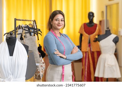 Young indian female fashion designer standing And giving happy expression at store. - Powered by Shutterstock