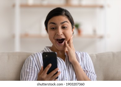 Young Indian Female Shocked By Unexpected Pleasant Surprise In Electronic Letter On Cellphone Screen. Happy Overwhelmed Mixed Race Woman Excited With News Of Being Hired Accepted To College University