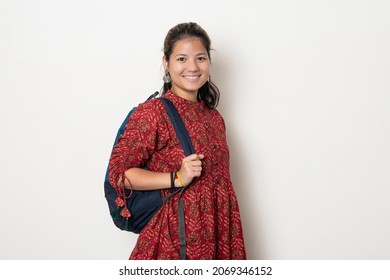 Young Indian Girl Getting Ready To Go To College, College Girl With A Bag On White Background.