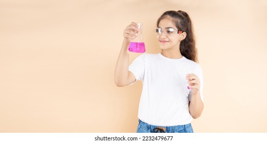 Young indian girl student doing science experiment holding colorful chemical flask isolated over beige background. Education concept. - Powered by Shutterstock