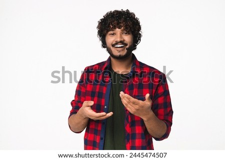 Young Indian hotline worker in headset consulting clients online isolated over white background. Hindi support manager dispatcher talking to customers remotely