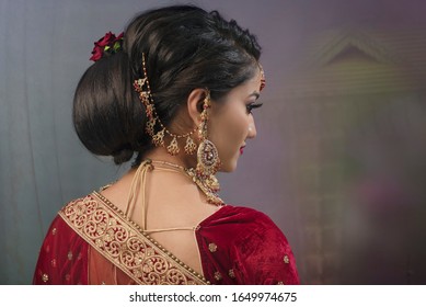 Young Indian lady with bridal wear, jewelry and make-up