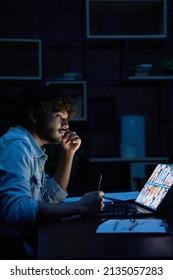 Young indian latin business man having remote video call conference team meeting working online by distant videocall web chat late at night at home in dark office using laptop computer. - Shutterstock ID 2135057283