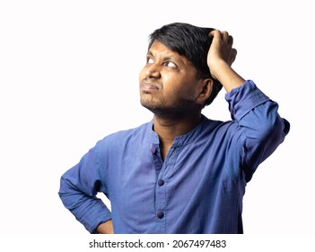 A Young Indian Male In Blue Dress Scratching Head And Thinking On White Background